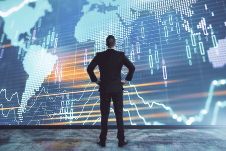Businessman and forex graph and world map hologram. Double exposure. Concept of financial education and analysisの写真素材