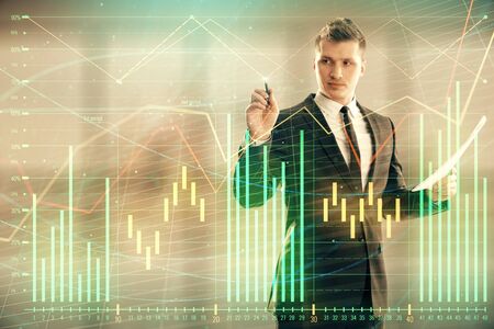 Businessman and forex graph hologram. Double exposure. Concept of financial education and analysisの写真素材