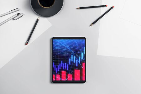 Digital tablet closeup top view with financial graph on screen. Online trading application concept. 3d rendering.の写真素材
