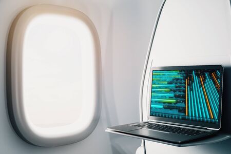 Laptop closeup inside airplane with forex graph on screen. Financial market trading concept. 3d rendering.の写真素材