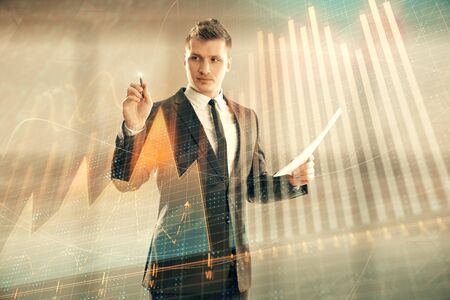 Businessman and forex graph hologram. Double exposure. Concept of financial education and analysisの写真素材