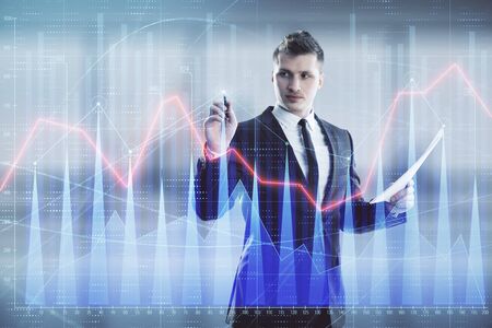 Businessman and forex graph hologram. Double exposure. Concept of financial education and analysisの写真素材