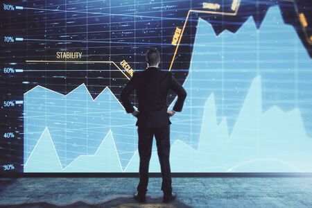 Businessman and forex graph hologram. Double exposure. Concept of financial education and analysisの写真素材