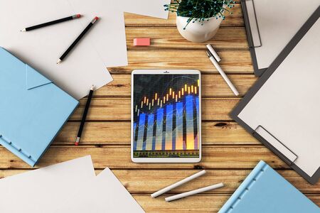 Digital tablet closeup top view with financial graph on screen. Online trading application concept. 3d rendering.の写真素材