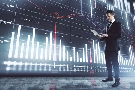 Businessman and forex graph hologram. Double exposure. Concept of financial education and analysisの写真素材