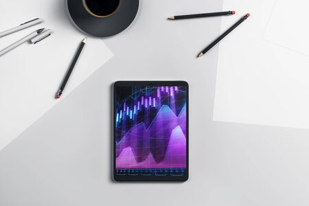 Digital tablet closeup top view with financial graph on screen. Online trading application concept. 3d rendering.の写真素材