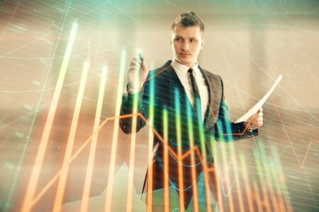 Businessman and forex graph hologram. Double exposure. Concept of financial education and analysisの写真素材