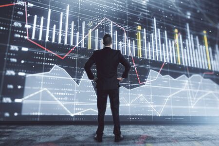Businessman and forex graph hologram. Double exposure. Concept of financial education and analysisの写真素材
