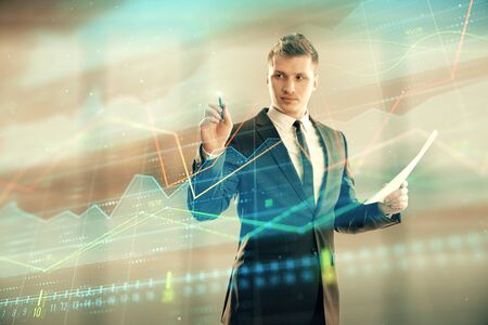 Businessman and forex graph hologram. Double exposure. Concept of financial education and analysisの写真素材