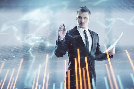 Businessman and forex graph and world map hologram. Double exposure. Concept of financial education and analysisの写真素材