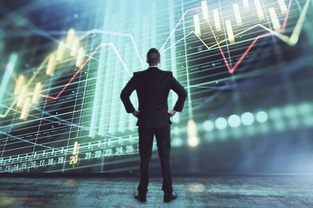 Businessman and forex graph hologram. Double exposure. Concept of financial education and analysisの写真素材