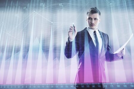 Businessman and forex graph hologram. Double exposure. Concept of financial education and analysisの写真素材