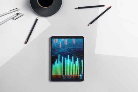 Digital tablet closeup top view with financial graph on screen. Online trading application concept. 3d rendering.の写真素材