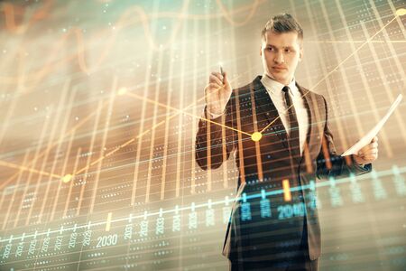 Businessman and forex graph hologram. Double exposure. Concept of financial education and analysisの写真素材