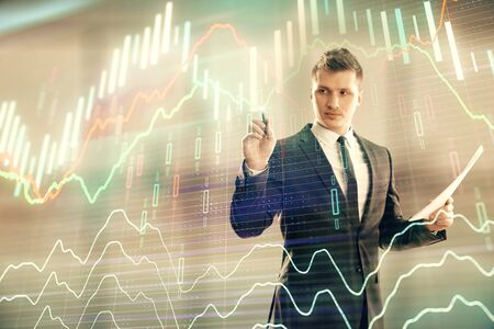 Businessman and forex graph hologram. Double exposure. Concept of financial education and analysisの写真素材