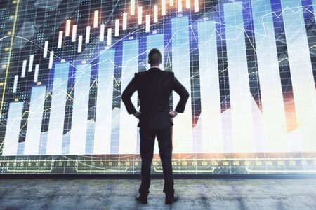 Businessman and forex graph hologram. Double exposure. Concept of financial education and analysisの写真素材
