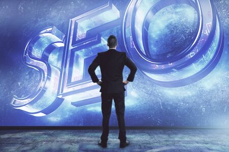Businessman and seo writing hologram. Double exposure. Concept of data optimizationの写真素材