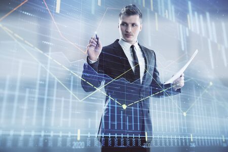 Businessman and forex graph hologram. Double exposure. Concept of financial education and analysisの写真素材
