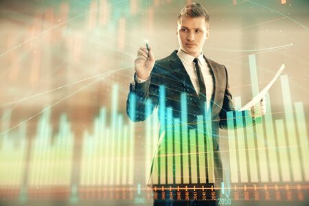 Businessman and forex graph hologram. Double exposure. Concept of financial education and analysisの写真素材