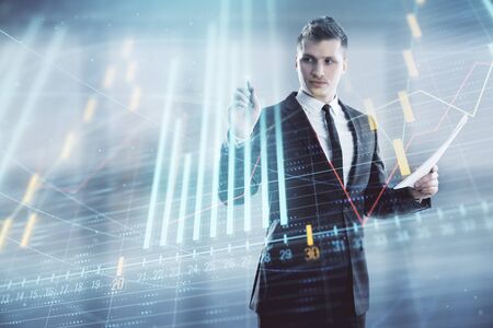 Businessman and forex graph hologram. Double exposure. Concept of financial education and analysisの写真素材