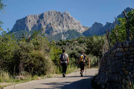 hikers in front of the Penyal des Migdia, 1401 meters, municipality of fornalutx, Mallorca, balearic islands, Spainの写真素材