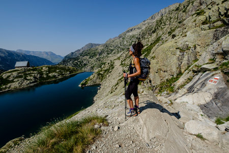 hiker on BachimaÃ±a reservoir, Ibones azul and BachimaÃ±a alto route, Huesca province, Spainのeditorial素材