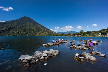women washing clothes, southwest of the caldera of Lake AtitlÃ¡n, Santiago AtitlÃ¡n. Guatemala, Central Americaのeditorial素材