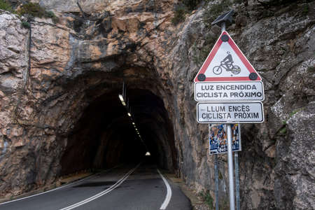 warning for cyclists in Spanish and Catalan, Puig Major tunnel, Fornalutx, Mallorca, Balearic Islands, Spainのeditorial素材