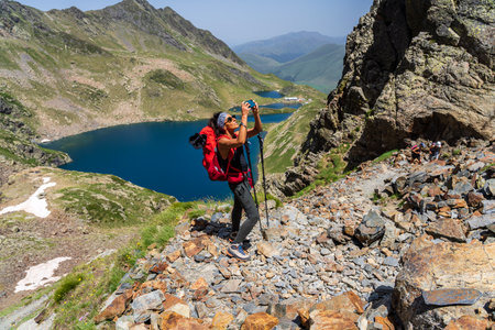 woman coming to the pass port of VÃ©nasque, Luchon, Pyrenean mountain range, Franceのeditorial素材