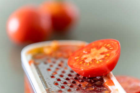 grating tomatoes for sauce, mallorca, spainの写真素材