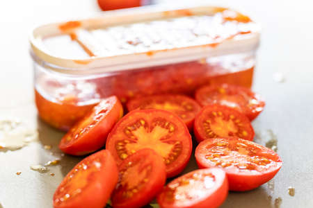 grating tomatoes for sauce, mallorca, spainの写真素材