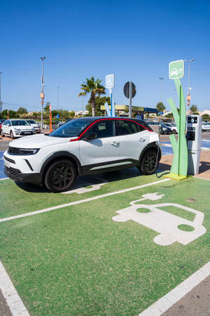 Electric car charging station symbol and car charging, Palma, Mallorca, spainの写真素材