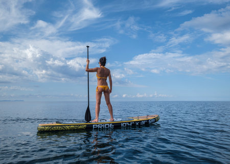 woman watching the distant horizon on a surfboard, Sa Rapita, Majorca, Balearic Islands, Spain