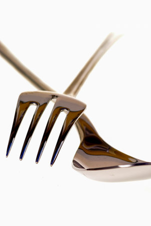 Covered in metal on white background, spoon and fork.の写真素材