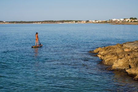 lonely woman practicing paddle surfing in the Mediterranean, Sa Rapita, Campos, Mallorca, Balearic Islands, Spainの写真素材