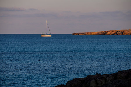 Sailboat in the sea at sunset, Sardinia, Italyの写真素材