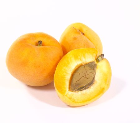 Few apricots on bright background with shadow. Is not isolated imageの写真素材