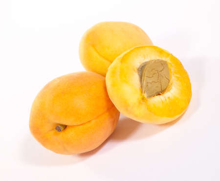Few apricots on bright background with shadow. Is not isolated imageの写真素材