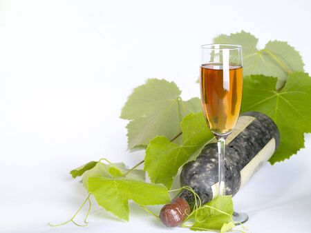 Old  wine still-life. Bottle and glass with grape vineの写真素材