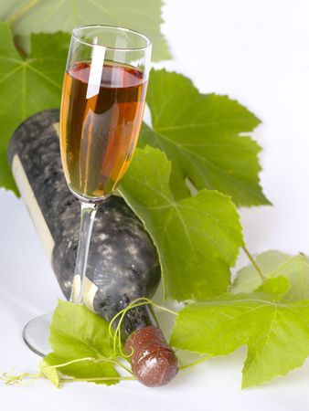 Old wine still-life. Bottle and glass with grape vineの写真素材