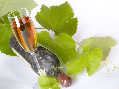 Old  wine still-life. Bottle and glass with grape vineの写真素材