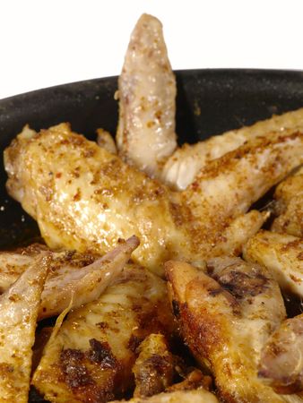 fried delicious chicken wings on the frying panの写真素材