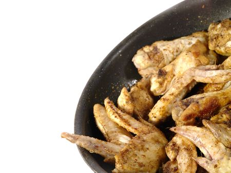 fried delicious chicken wings on the frying panの写真素材