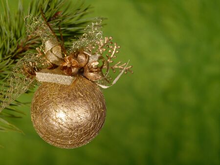 Xmas golden ball on the green background. Green is life colour in natureの写真素材