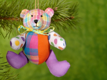 Xmas handmaded teddybear on the green background.の写真素材