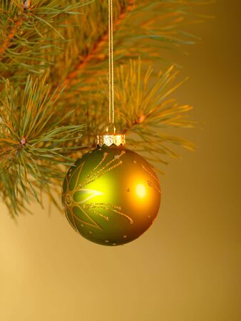 Xmas toys on the golgen background with orange spotlight.の写真素材