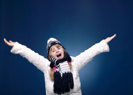 Happy Female Child posing over blue backgroundの写真素材