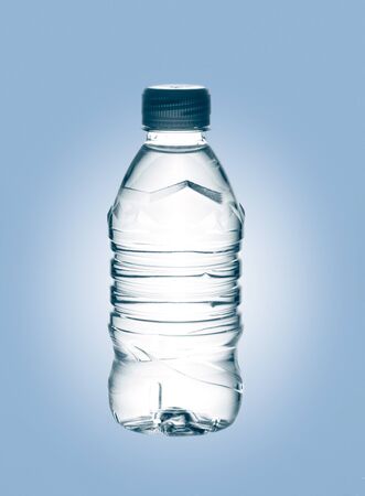 purified spring mineral water in the bottle over blue baclgroundの写真素材
