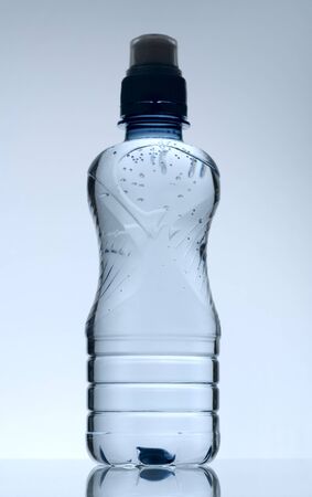 Purified mineral water on the wet glass desk with reflectionの写真素材