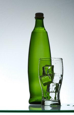 Purified mineral water on the wet glass desk with reflectionの写真素材